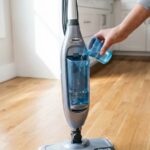 Person using Shark floor cleaner on hardwood floors in USA home