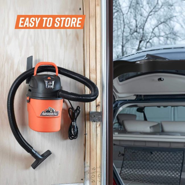 Compact Armor All AA155 portable vacuum picking up dust, dirt, pet hair, and liquid spills