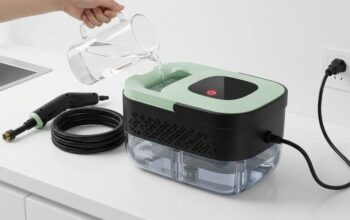 Handheld pressurized steam cleaner resting on clean kitchen countertop